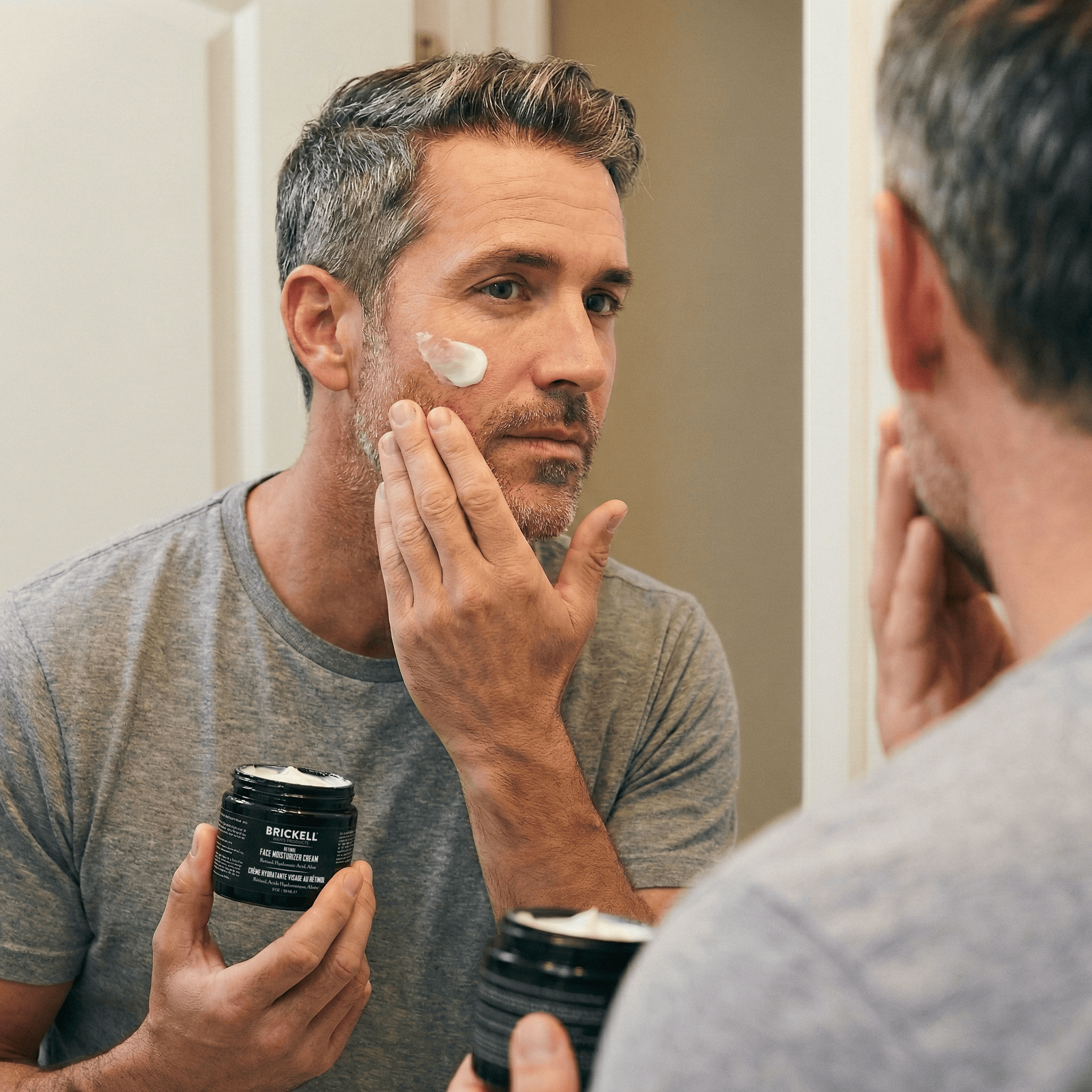 Man using retinol in mirror